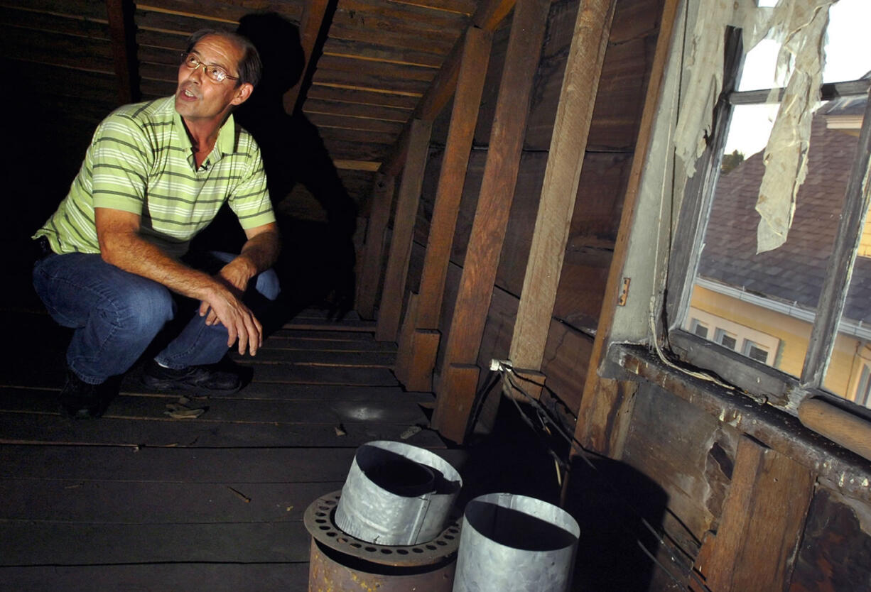 Karl Kissner explains Tuesday where he found a box of century-old baseball cards in the attic in his grandfather's old home in Defiance, Ohio.