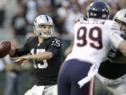 Oakland Raiders quarterback Matt Flynn (15) looks to throw as Chicago Bears defensive end Shea McClellin (99) rushes during the first quarter of an NFL preseason football game in Oakland, Calif., Friday, Aug. 23, 2013.