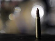 A bullet sits on a table during a discussion on gun control.