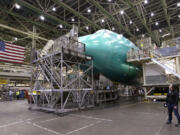 A visitor looks up at a Boeing 747 jet being assembled at the company's production plant in Everett in May.