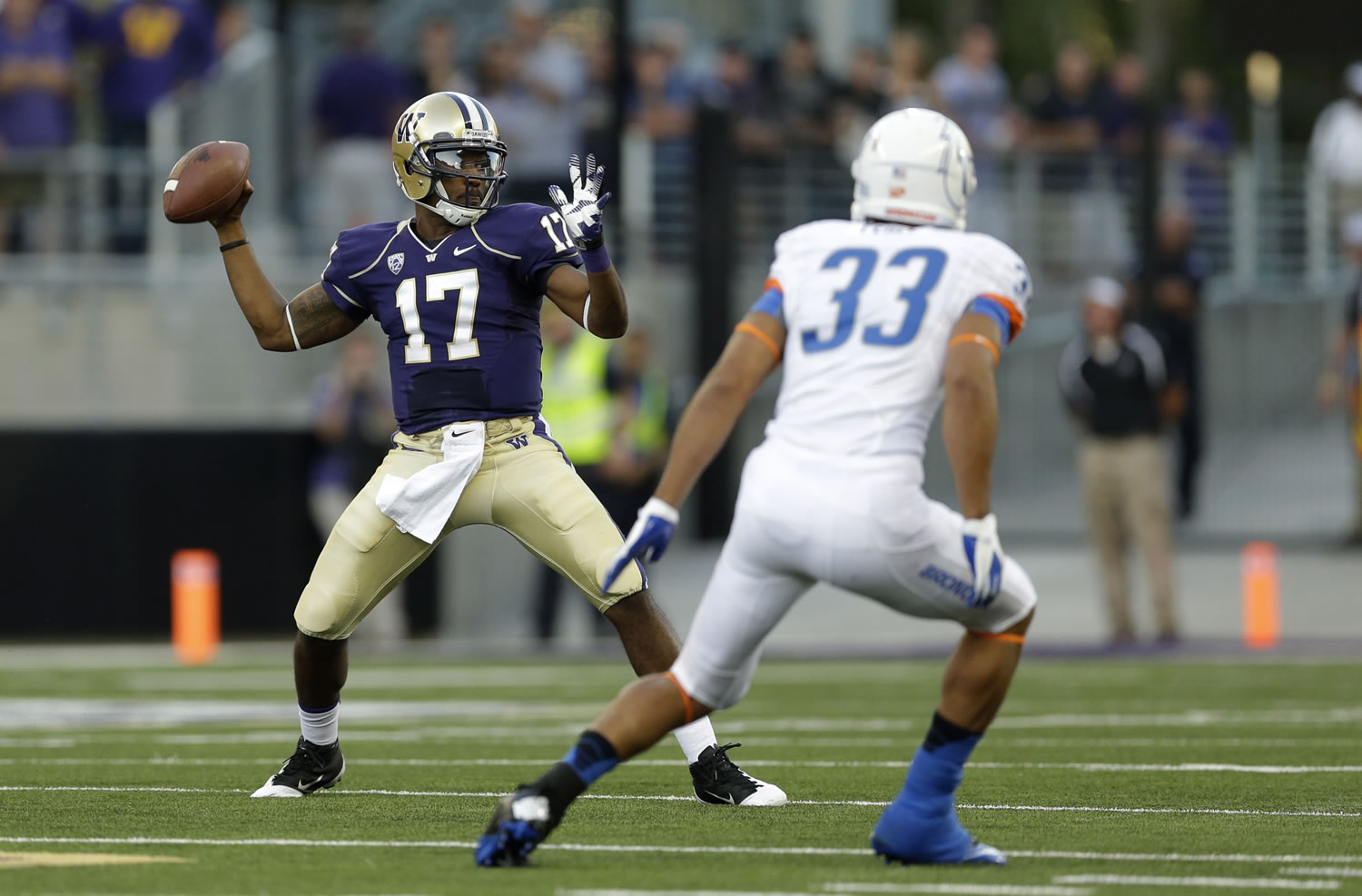 Washington quarterback Keith Price (17) looks to pass around Boise State's Gabe Perez (33) in the first half Saturday.