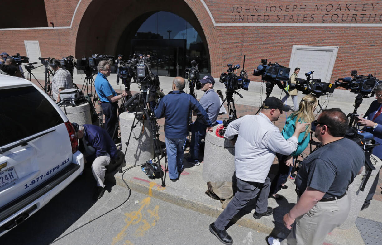 Television cameramen wait outside the Moakley Federal Courthouse in Boston on Wednesday.