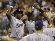 Milwaukee Brewers' Yuniesky Betancourt, left, a former Seattle Mariner, is greeted at the plate after he hit a grand slam against his former club in the fifth inning Friday at Safeco Field.