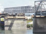 Workers install the temporary bridge extension Monday over the Skagit River on Interstate 5 on the southern end of the span.