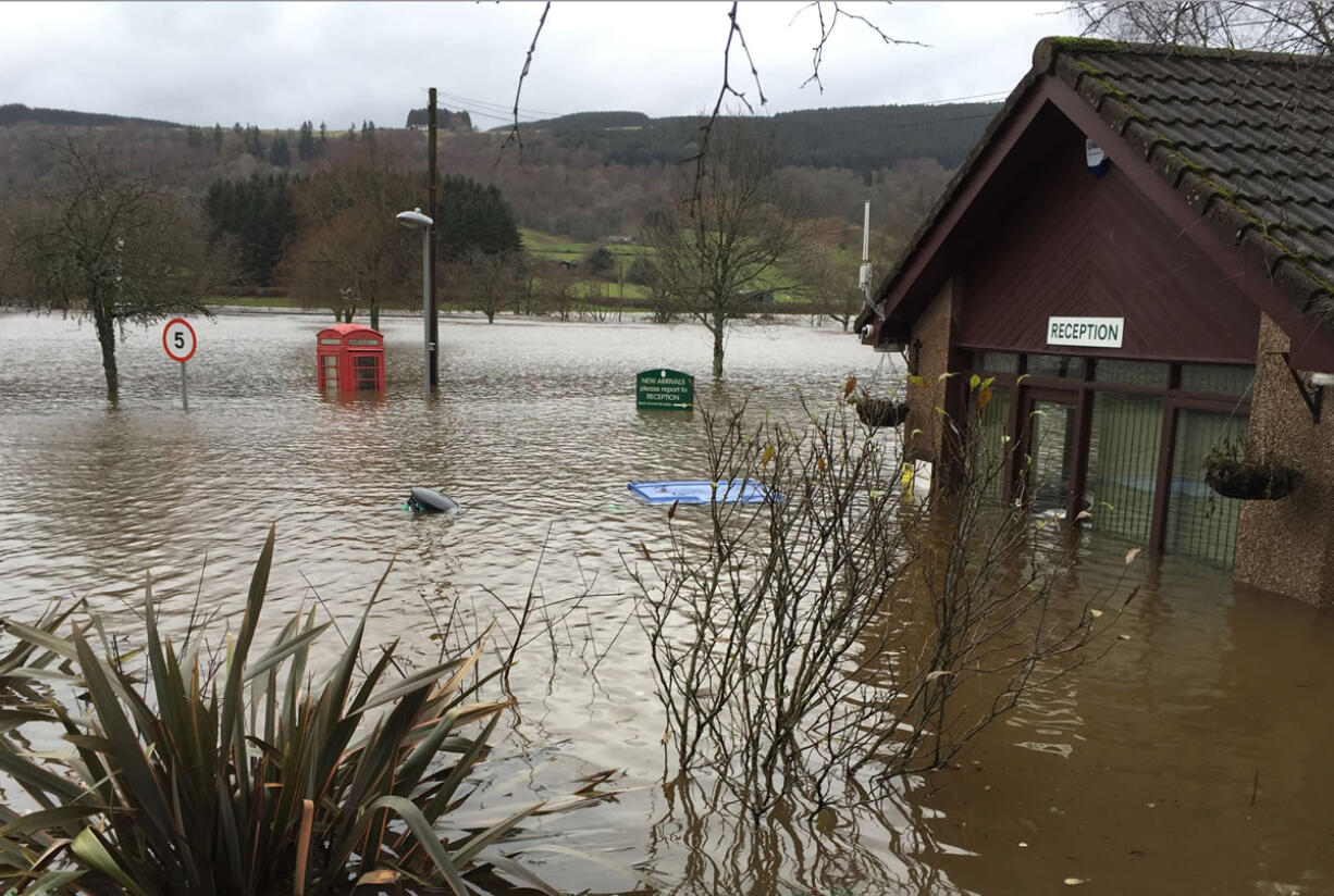 A red telephone box is partially submerged by floodwaters Wednesday in Perthshire, Scotland.