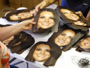 Workers from the Mask-arade mask company sort Kate, Duchess of Cambridge masks ready for dispatch June 6 at the company works in Southam, England. Mask-arade are in overdrive printing masks of Kate and William for the street parties that will follow the announcement of the birth of the Royal baby, expected in July.