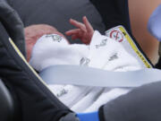 Prince George of Cambridge lays in a car seat July 23 as his parents, Britain's Prince William and Kate, Duchess of Cambridge leave St.