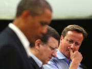 Britain's Prime Minister David Cameron, right, attends a news conference with U.S.