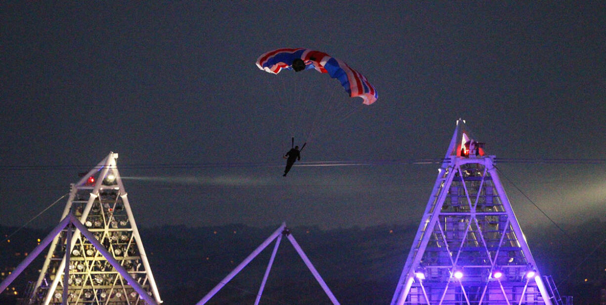 British stuntman Mark Sutton parachutes into Olympic Stadium dressed as James Bond during the Olympic Games 2012 Opening Ceremony on July 27, 2012.