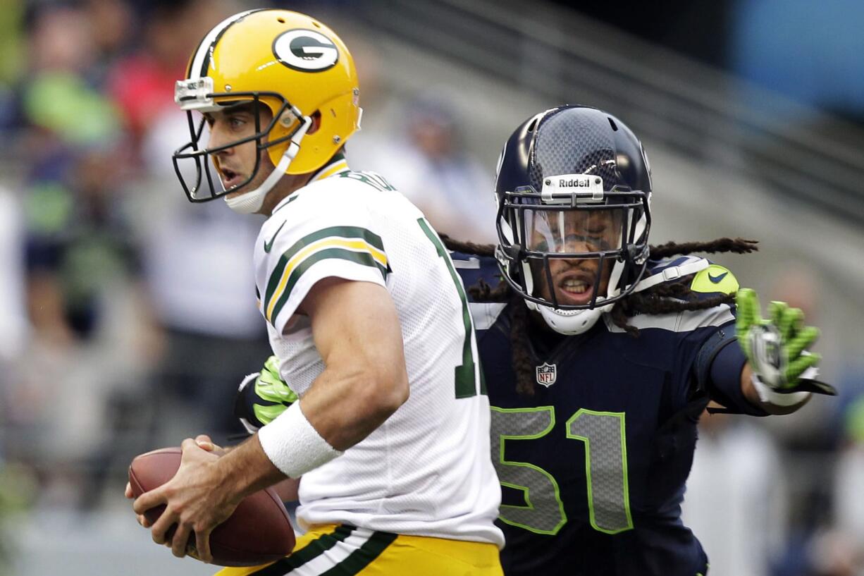 Packers quarterback Aaron Rodgers, left, is sacked by Seahawks defensive end Bruce Irvin earlier this season.