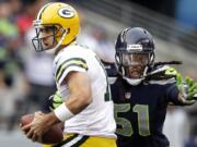 Packers quarterback Aaron Rodgers, left, is sacked by Seahawks defensive end Bruce Irvin earlier this season.