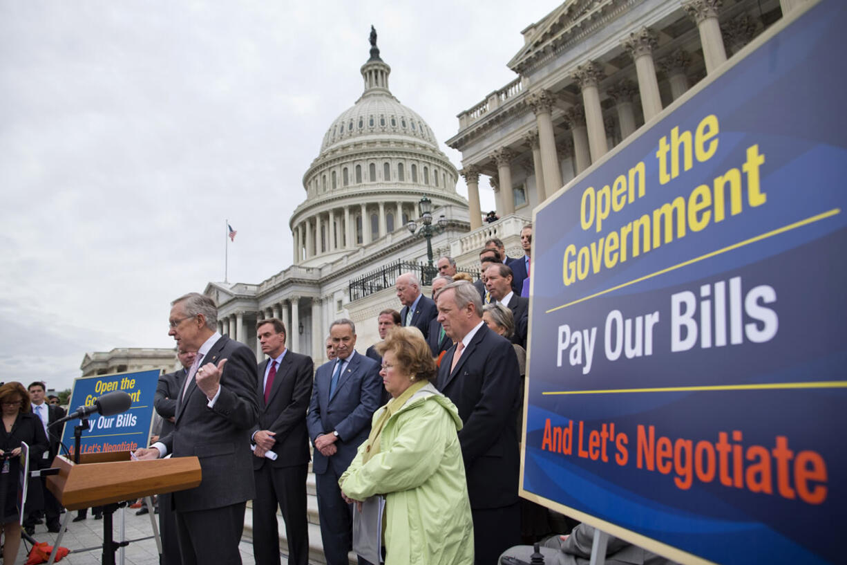 Senate Majority Leader Harry Reid of Nev., at podium, speaks during a news conference on the Senate steps on Capitol Hill in Washington on Wednesday to discuss the ongoing budget battle.