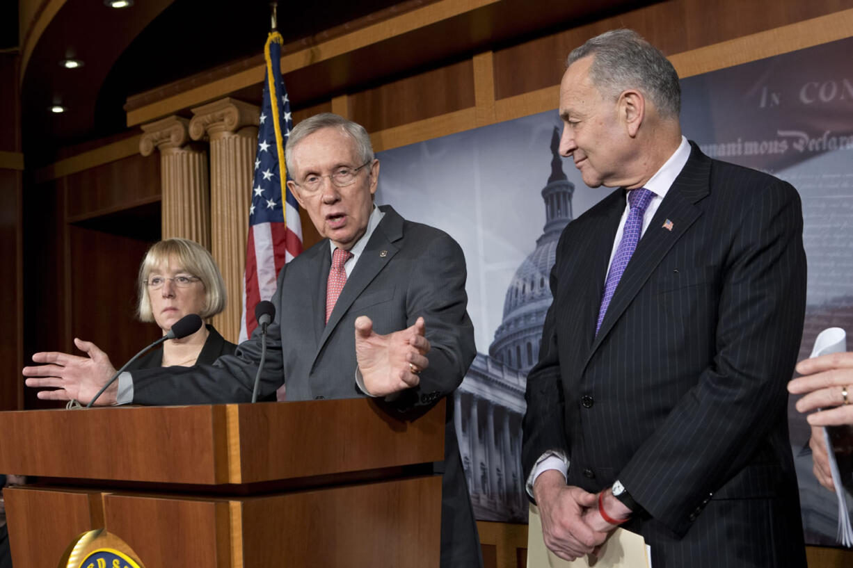 Senate Majority Leader Harry Reid, D-Nev., center, joined by Senate Banking Committee Chair Sen. Patty Murray, D-Wash., left, and Sen.