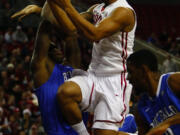 Washington State's DaVonte Lacy goes to the basket by two Buffalo players at KeyArena in Seattle on Friday night.