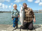 Matix Pardue poses with his dad, Eli, and a fall chinook salmon caught in the Buoy 10 fishery at the mouth of the Columbia River in 2012.