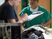 Student and licensed veterinary technician Monica Conklin, left, monitors Mr. Moo under anesthesia before he is moved into the operating room for his cleft palate surgery at Michigan State University&#039;s College of Veterinary Medicine in East Lansing, Mich. A partnership between a children&#039;s hospital and a veterinary school is turning out to be a win-win for canines and kids alike. (G.L.