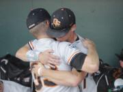 Oregon State's Ryan Barnes (33) and Joey Jansen hug after losing 4-1 to Mississippi State on Friday.