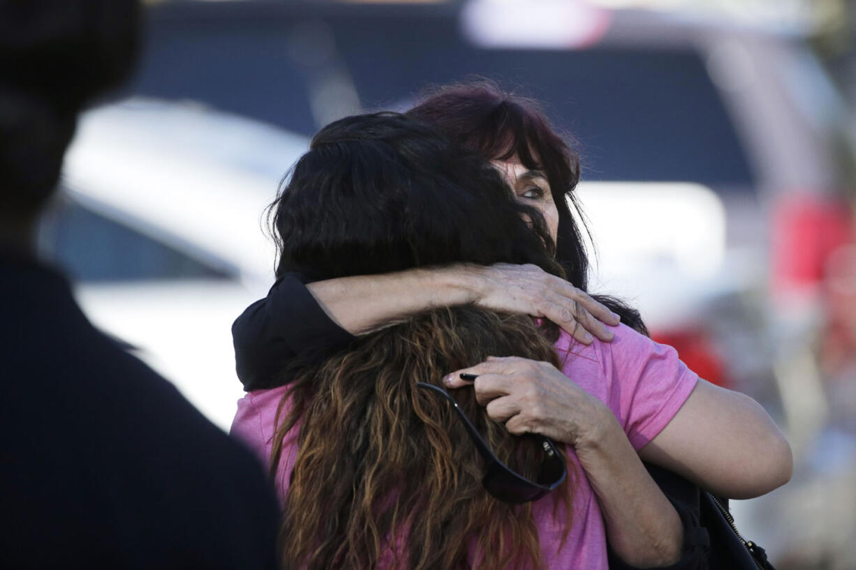 Teresa Hernandez, facing camera, is comforted by a woman as she arrives at a social services center in San Bernardino, Calif., where one or more gunmen opened fire, shooting multiple people on Wednesday, Dec. 2, 2015. (AP Photo/Jae C.