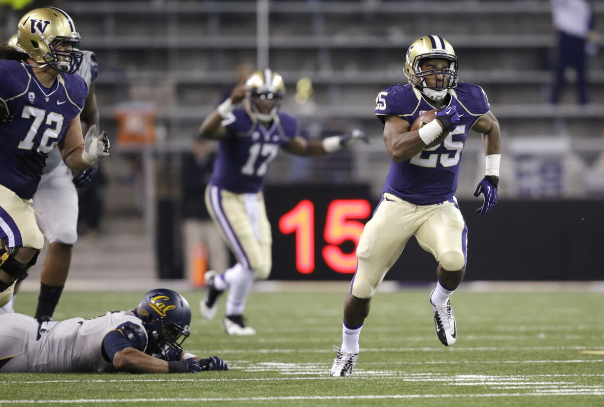 Washington's Bishop Sankey (25) takes off on a 59-yard touchdown run as quarterback Keith Price (17) cheers behind in the first half of an NCAA college football game against California Saturday, Oct. 26, 2013, in Seattle.