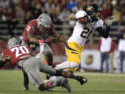 California wide receiver Keenan Allen (21) avoids the tackle attempt by Washington State safety Deone Bucannon (20) and linebacker Eric Oertel (21) as he scores scores a touchdown.