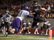 Camas running back Nate Beasley scores in the first half against Heritage at Doc Harris Stadium, Friday, October 25, 2013.