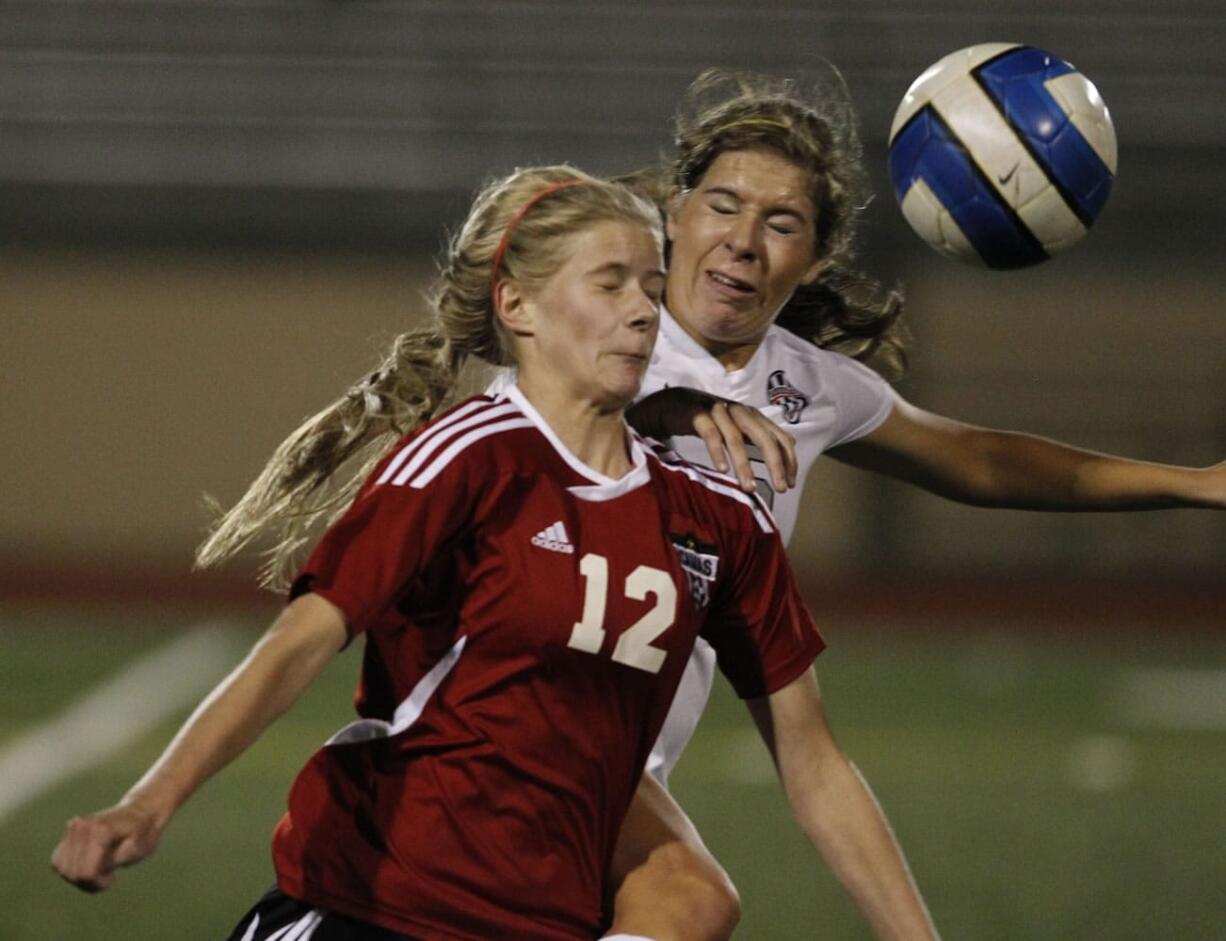 Union defender Nicole Blake (R) and Camas forward Riley Allison (12) battle for the ball.