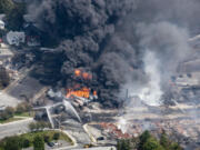 Smoke rises from railway cars Saturday that were carrying crude oil after derailing in downtown Lac Megantic, Quebec, Canada.