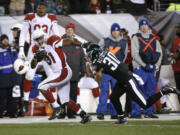 Arizona Cardinals' David Johnson, left, breaks free of Philadelphia Eagles' Ed Reynolds on a touchdown run during the first half of an NFL football game, Sunday, Dec. 20, 2015, in Philadelphia.