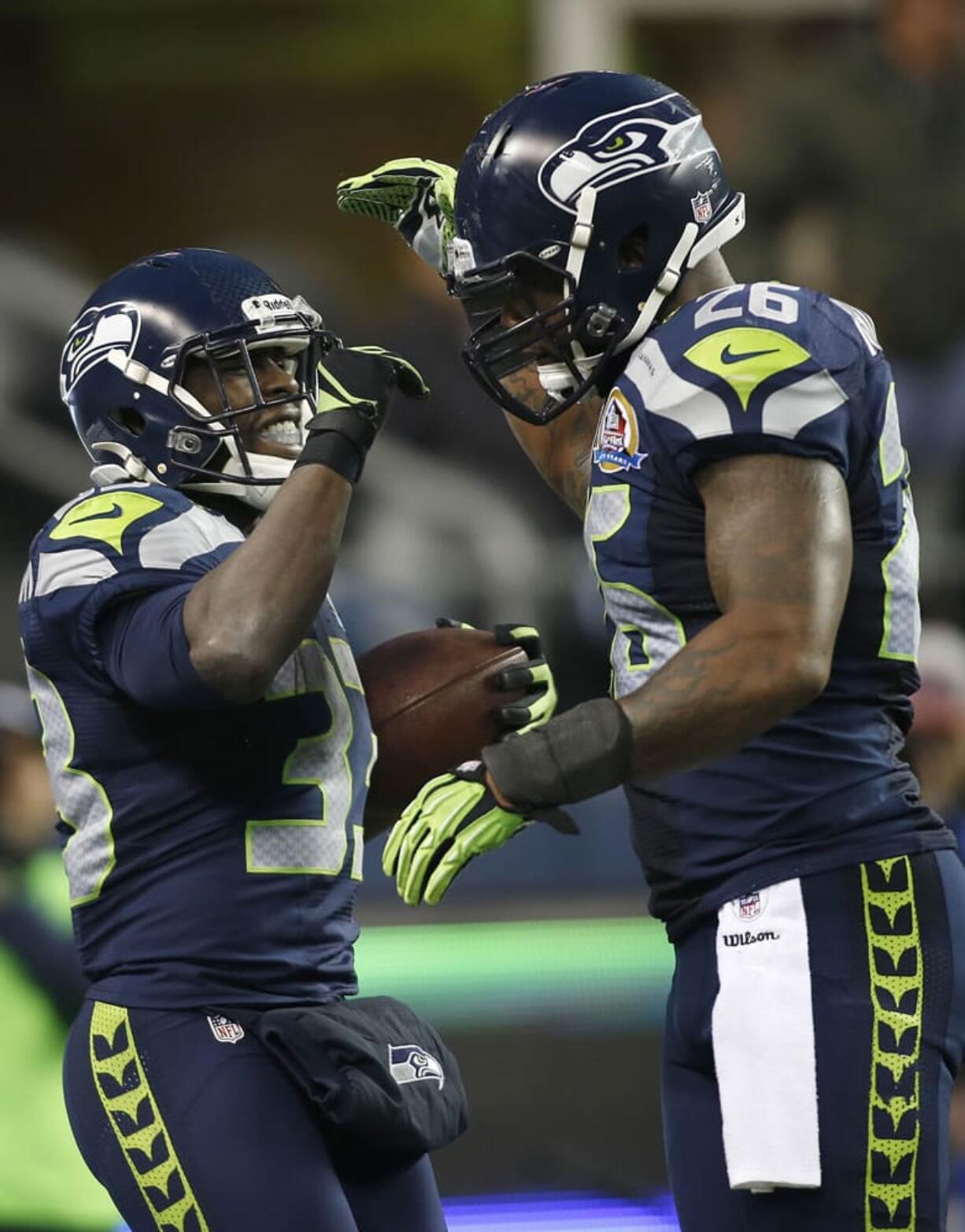 Leon Washington (33) celebrates with fullback Michael Robinson (26) after scoring on a 3-yard touchdown run against the Arizona Cardinals.