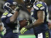 Leon Washington (33) celebrates with fullback Michael Robinson (26) after scoring on a 3-yard touchdown run against the Arizona Cardinals.