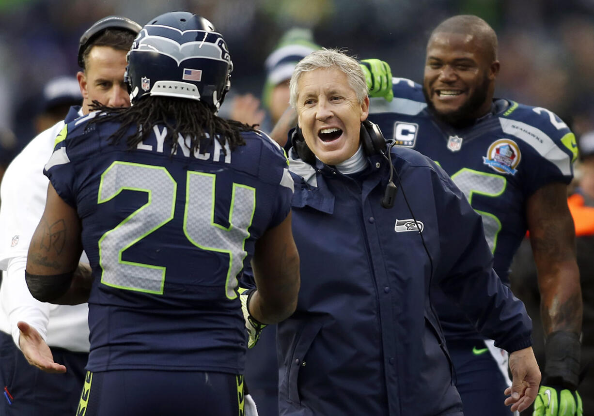 Seattle Seahawks head coach Pete Carroll congratulates running back Marshawn Lynch (24) after Lynch scored on a 20-yard touchdown run during the first quarter of an NFL football game against the Arizona Cardinals in Seattle, Sunday, Dec. 9, 2012.