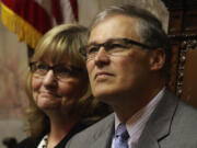 As the special session nears its end, Gov. Jay Inslee and wife Trudi Inslee are seen on the floor of the Washington Senate on Monday in Olympia during a memorial for the late Sen.