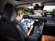 The driver of a Volvo in a road test of self-driving cars.