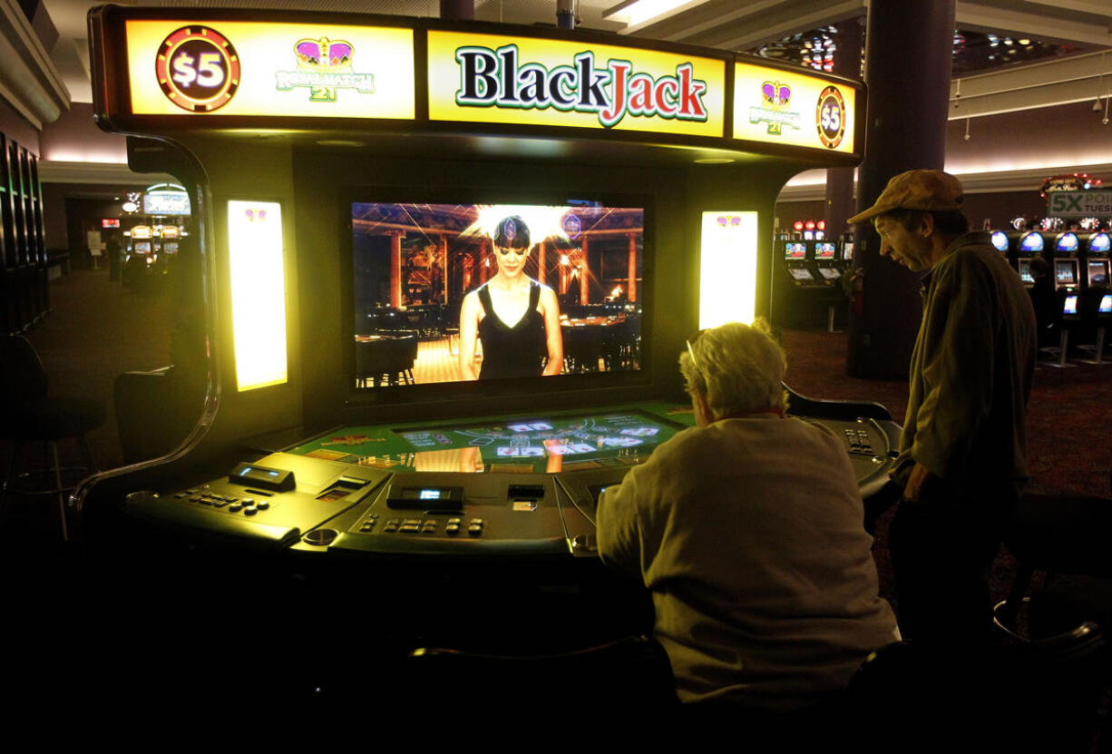 Patrons play at an electronic Blackjack table at the Newport Grand slot parlor in Newport, R.I. Voters in Rhode Island, Oregon and Maryland will decide Nov.