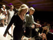 Cathy Rae Kudla walks next to her collection on the spring Couve Couture runway in April.