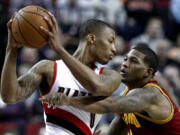 Cleveland Cavaliers forward Alonzo Gee, right, pressures Portland Trail Blazers guard Damian Lillard during the first quarter of an NBA basketball game in Portland, Ore., Wednesday, Jan. 16, 2013.