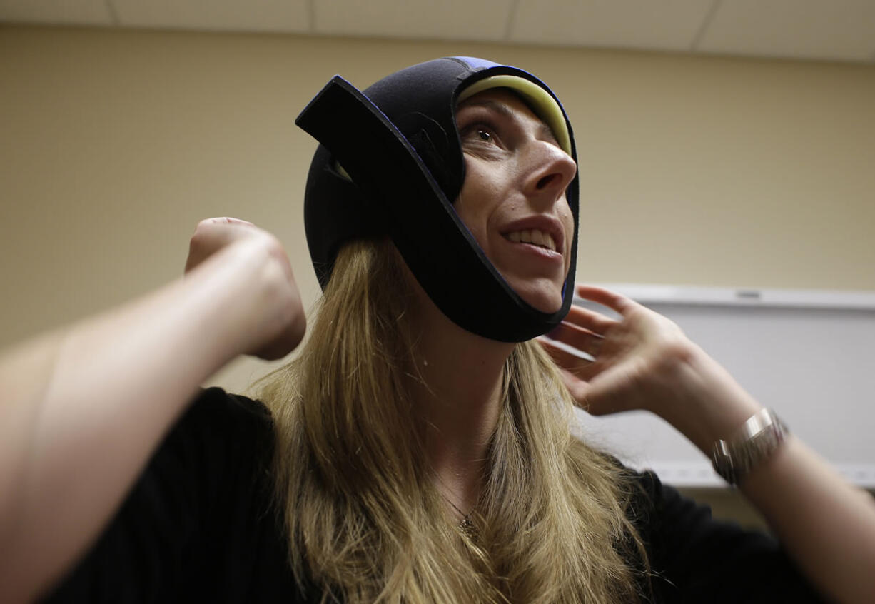 Katherine Serrurier, a research assistant and pre-medical intern, demonstrates the use of the Dignitana DigniCap system at the University of California San Francisco Mount Zion Hospital cancer center in San Francisco.