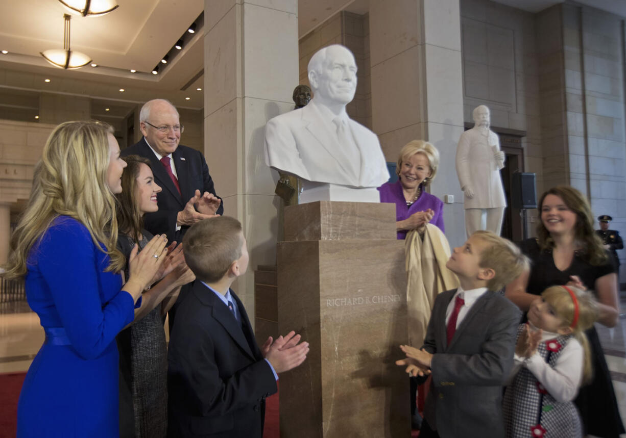 Former Vice President Dick Cheney, back left, his wife Lynne Cheney, back right, and their grandchildren applaud as his marble bust is unveiled in the Emancipation Hall on Capitol Hill in Washington, Thursday, Dec. 3, 2015. Congressional leaders and former President George W. Bush paid tribute to Cheney, who also served as congressman from Wyoming.