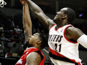 Trail Blazers center J.J. Hickson blocks a shot from the Clippers' DeAndre Jordan, but Portland couldn't muster enough defense to pull out a comeback victory.