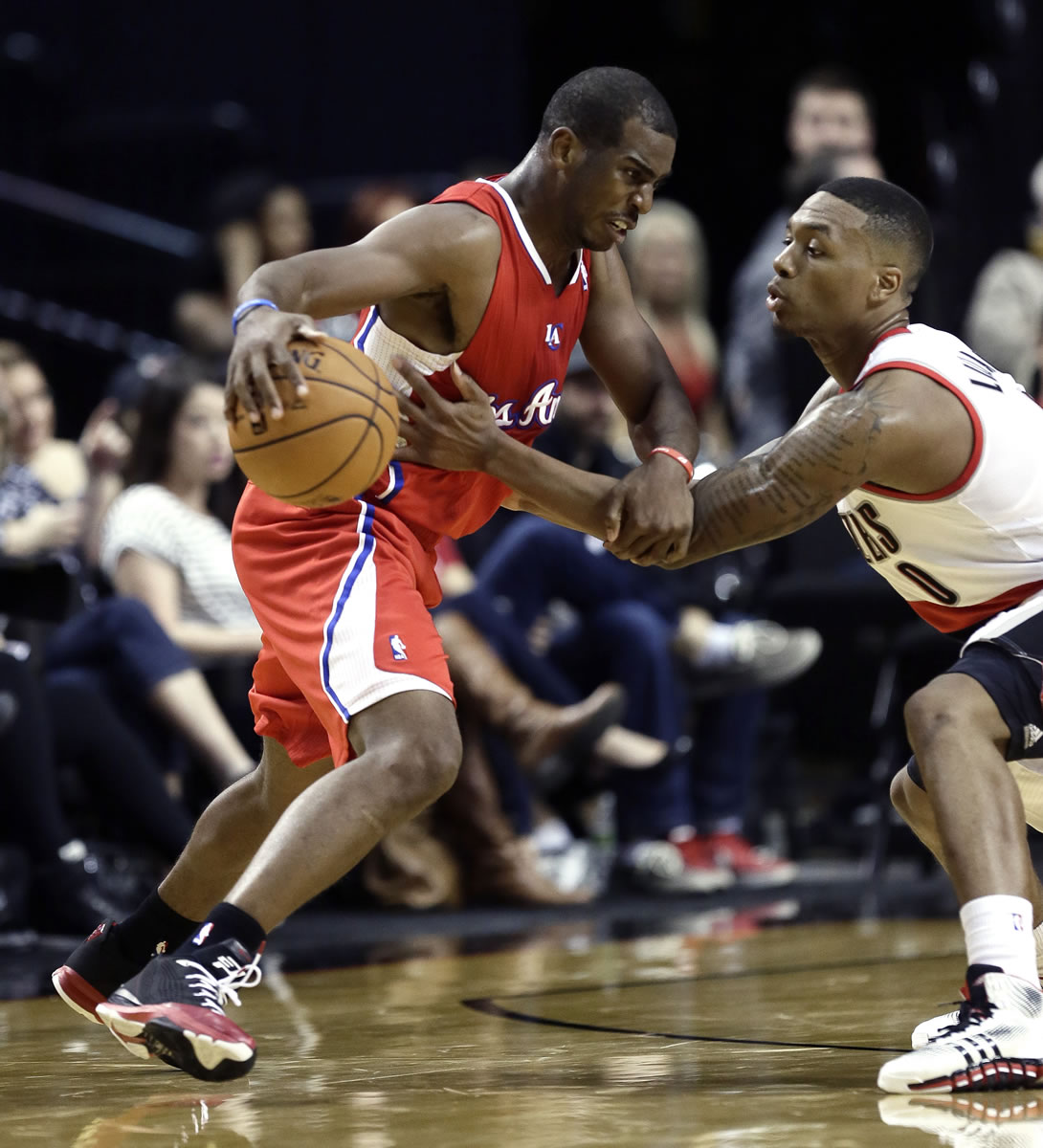 Portland guard Damian Lillard, right, defends Los Angeles Clippers guard Chris Paul in a preseason game Monday.