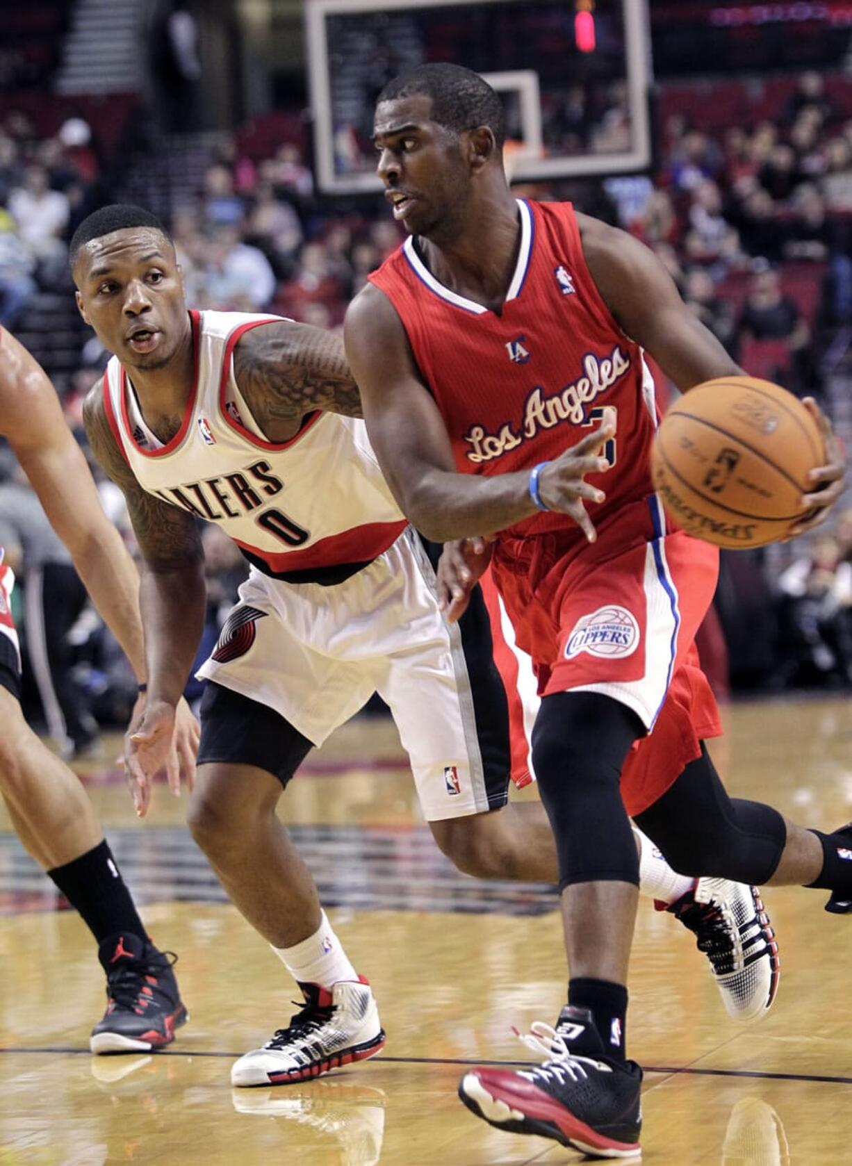 Clippers guard Chris Paul, right, drives on Portland's Damian Lillard during the first half Monday.