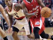 Clippers guard Chris Paul, right, drives on Portland's Damian Lillard during the first half Monday.