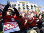 Russ Childers, left, of Seattle, sits among other protesters as they demonstrate against trains carrying coal for export moving through Washington state on Thursdayin Tacoma. The protest occurred prior to the fifth and final public hearing on the environmental impact statement for a proposed coal export terminal in Longview.