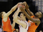 Indiana forward Cody Zeller (40) is trapped between Syracuse guard Brandon Trich, left, and forward Rakeem Christmas (25) during the first half of an East Regional semifinal in the NCAA college basketball tournament, Thursday, March 28, 2013, in Washington.