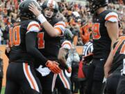 Oregon State's quarterback Sean Mannion (4) congratulates Caleb Smith (10) on his touchdown reception against Colorado in the first half Saturday.