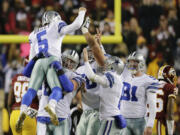 Dallas Cowboys kicker Dan Bailey (5) celebrates his game winning field goal with his teammates during the second half of an NFL football game against the Washington Redskins in Landover, Md., Monday, Dec. 7, 2015. The Dallas Cowboys defeated the Washington Redskins 19-16.