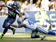 Seattle Seahawks' Marshawn Lynch (24) rushes past Dallas Cowboys' Danny McCray during the second half Sunday.