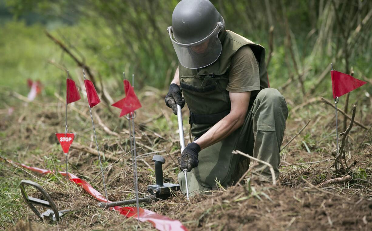 Ante Ivanda, a de-miner, searches for land mines in Petrinja, central Croatia, on Friday.