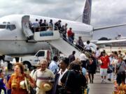 Passengers aboard the first flight of Continental Airlines from Miami, Fla., to Cuba arrive at Jose Marti Airport in Havana on Nov. 1, 2001.