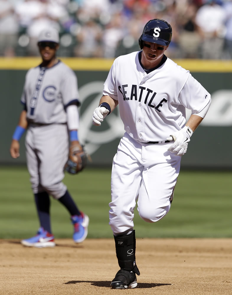 Seattle Mariners' Justin Smoak, right, rounds the bases as Chicago Cubs shortstop Starlin Castro watches after Smoak's home run in the second inning Saturday.